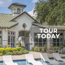 a pool with chairs in front of a building