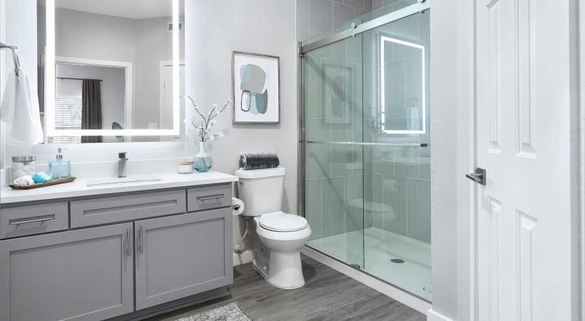 a bathroom with a shower, toilet and sink