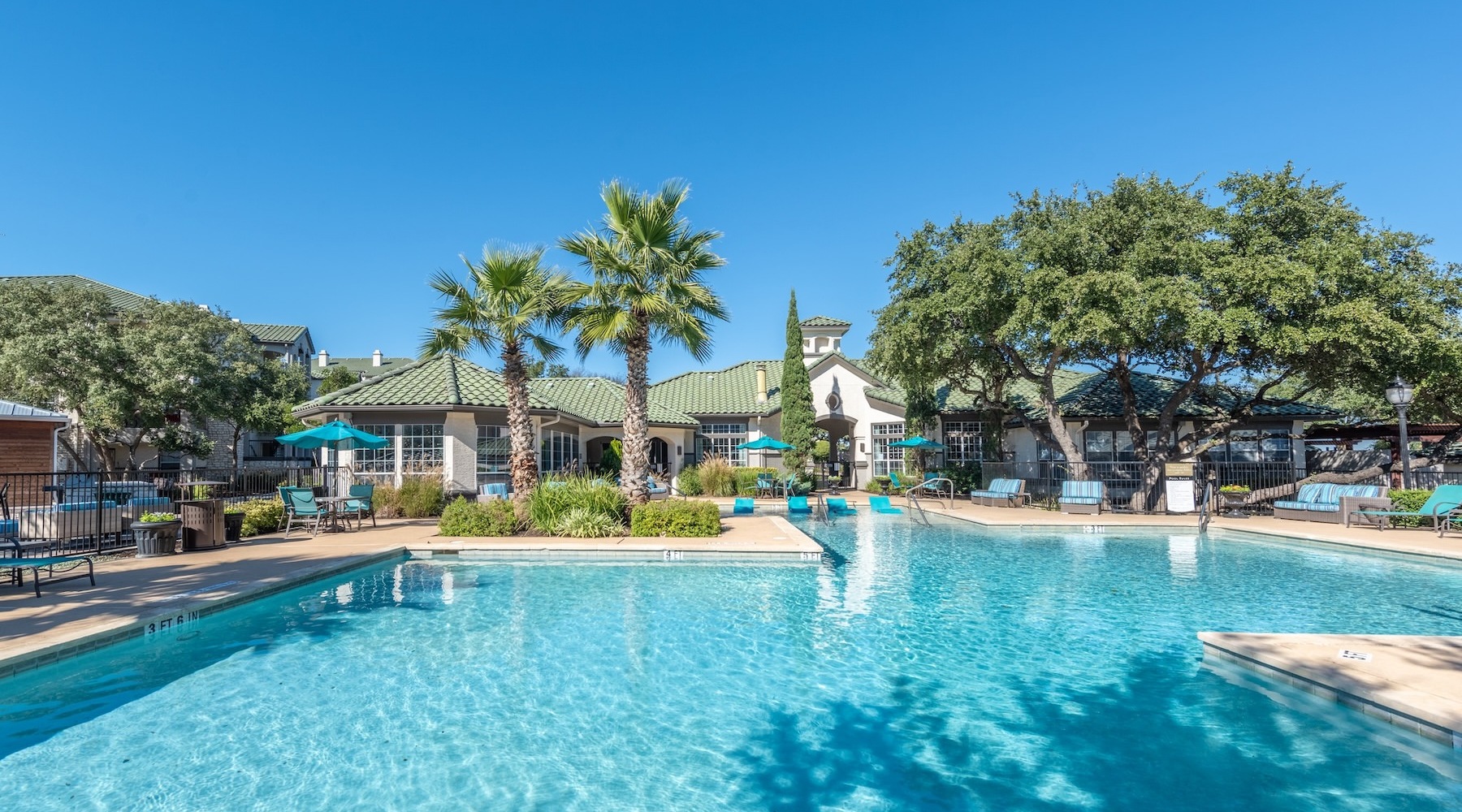 a swimming pool with a building and trees